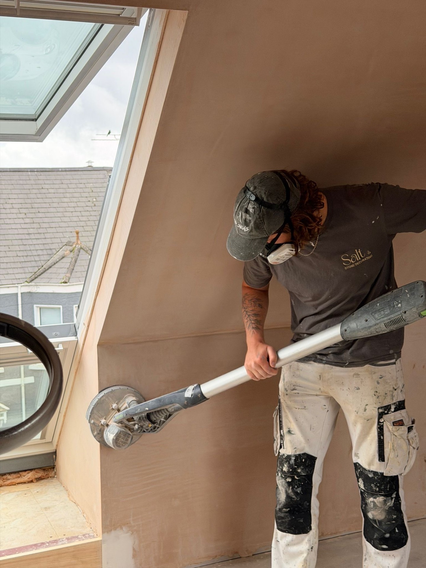 Professional painter sanding wall — Salt & Stone Decorating Cornwall